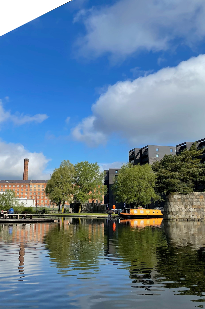 Ancoats Marina or New Islington Marina in the sun with a canal boat